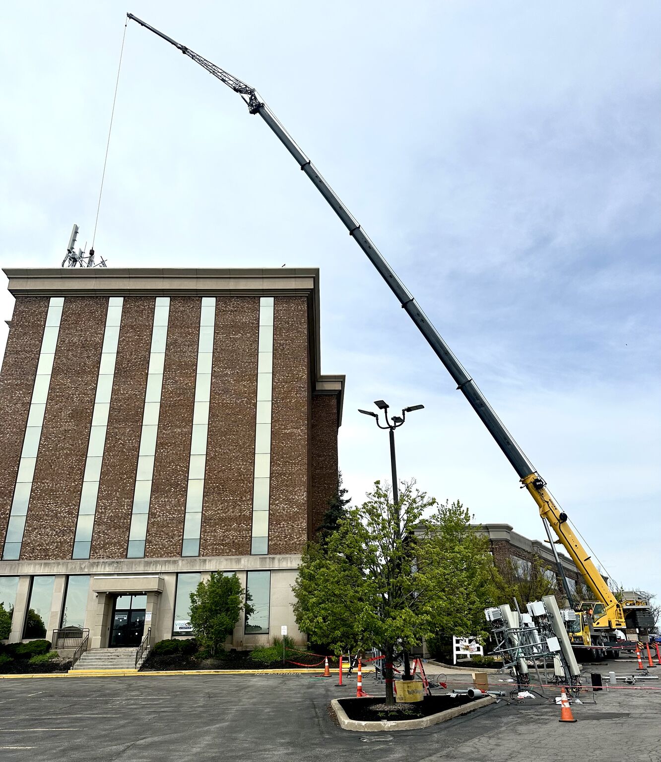 telecom A crane lifting a very large metal LP tank