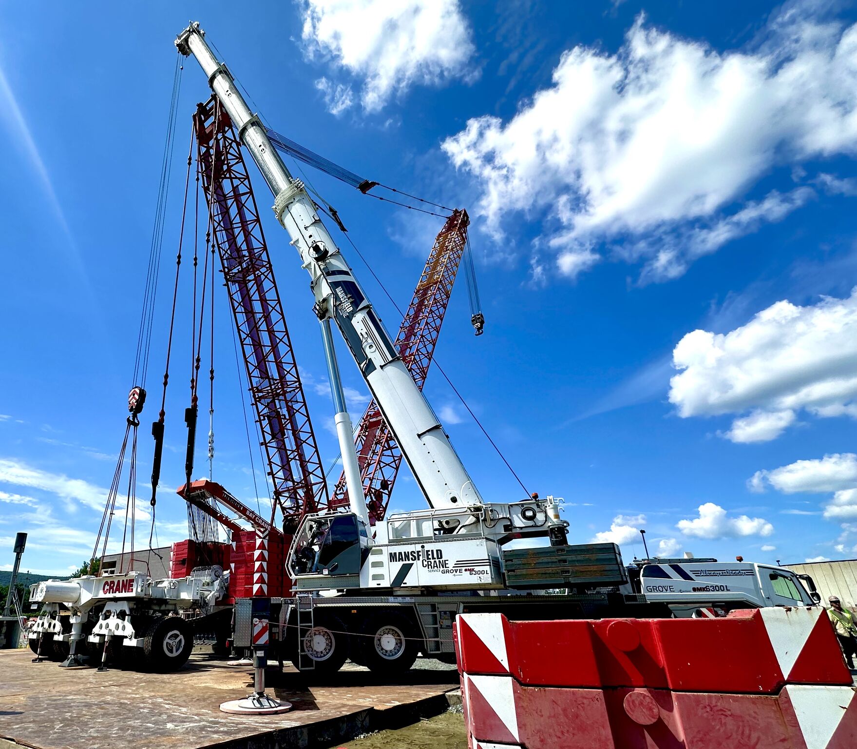 A crane lifting a very large metal LP tank