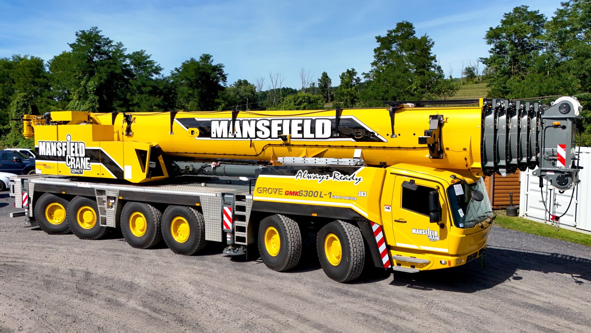 A crane lifting a very large metal LP tank